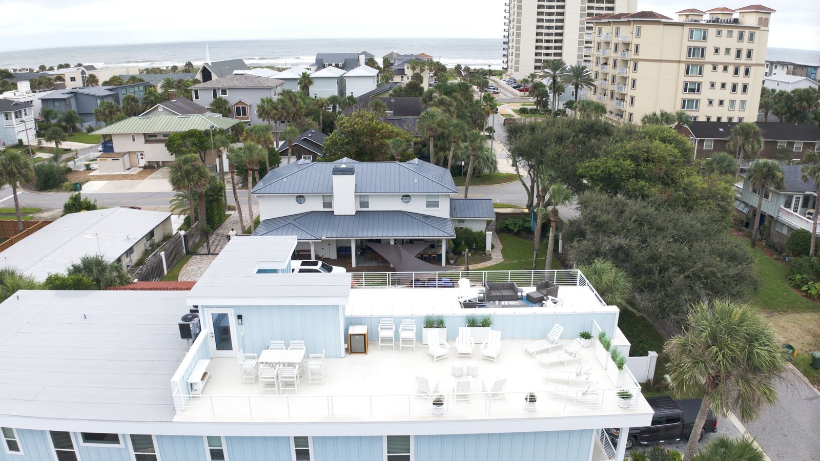 Aerial view of a Jacksonville Beach short term rental with the ocean behind it