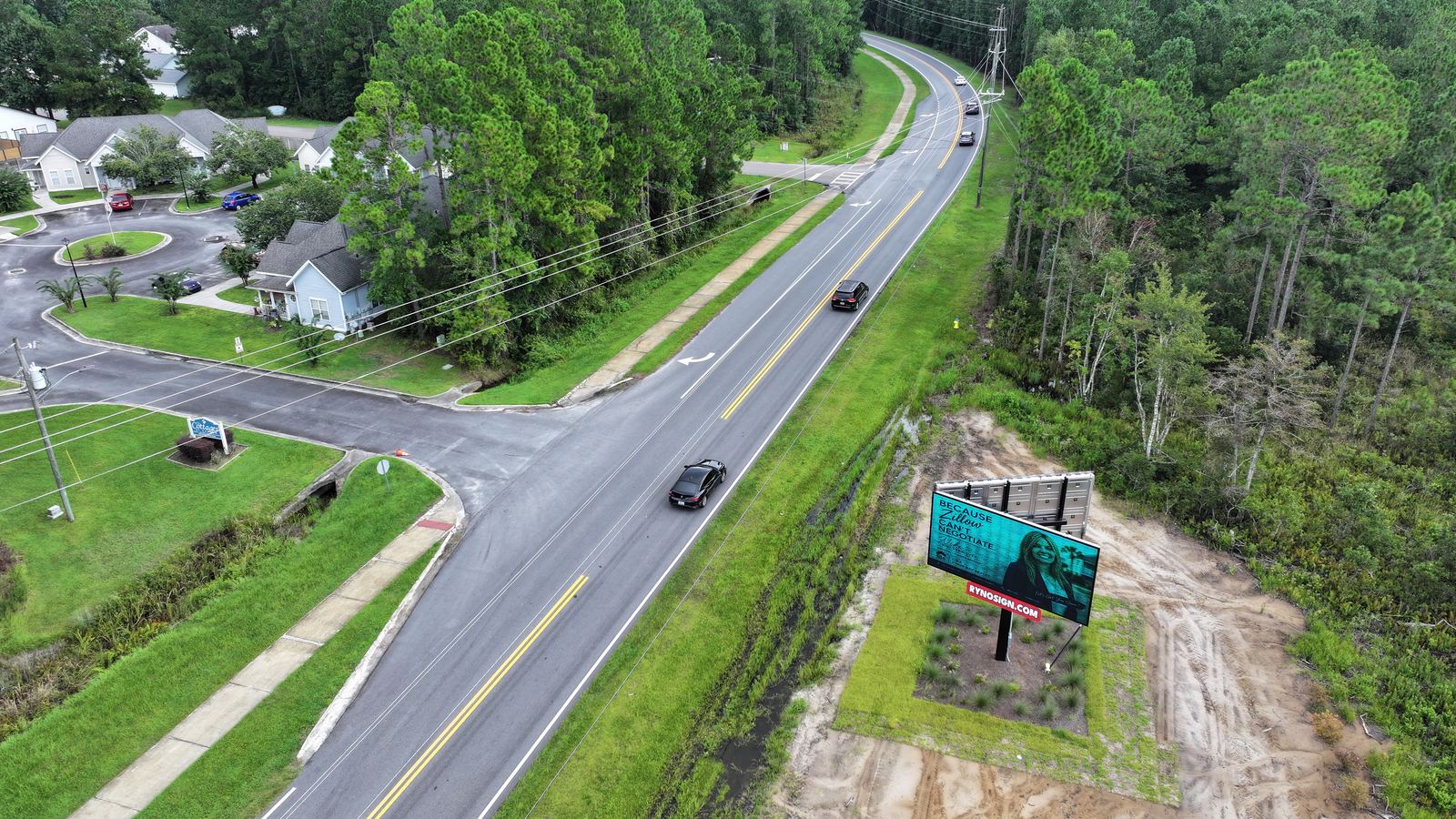 Frontage parcel with road and neighboring homes